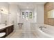 Spa-like bathroom with soaking tub, walk-in shower, and double vanity at 696 Regatta Way, Bradenton, FL 34208