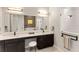 Elegant bathroom with double sinks, modern cabinets, and a large mirror at 696 Regatta Way, Bradenton, FL 34208