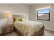 Bright bedroom with window seat and patterned bedding at 696 Regatta Way, Bradenton, FL 34208