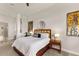 Comfortable bedroom features a king-size bed and large artwork at 696 Regatta Way, Bradenton, FL 34208