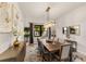 Bright dining room featuring a wood table and modern chandelier at 696 Regatta Way, Bradenton, FL 34208