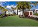 Charming white home with a well-manicured lawn and colorful landscaping at 696 Regatta Way, Bradenton, FL 34208