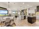 Open concept kitchen with island, dining area, and water views at 696 Regatta Way, Bradenton, FL 34208