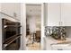 Modern kitchen with double oven and view into dining area at 696 Regatta Way, Bradenton, FL 34208