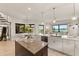 Modern kitchen island with water views and stainless steel appliances at 696 Regatta Way, Bradenton, FL 34208