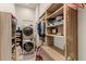 Bright laundry room with washer, dryer, and ample storage shelving at 696 Regatta Way, Bradenton, FL 34208