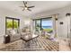 Living room with water views, comfortable seating, and a fireplace at 696 Regatta Way, Bradenton, FL 34208