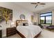 Main bedroom with water views, featuring a king-size bed and sitting area at 696 Regatta Way, Bradenton, FL 34208