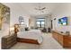 Main bedroom features water views and a large TV at 696 Regatta Way, Bradenton, FL 34208