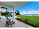 Waterfront patio with seating, overlooking the water and boat at 696 Regatta Way, Bradenton, FL 34208