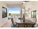 Covered patio with seating area, overlooking pool and waterfront at 696 Regatta Way, Bradenton, FL 34208
