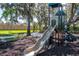 Community playground with slide, climbing structure, and benches at 696 Regatta Way, Bradenton, FL 34208