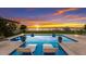 Stunning pool with sunset view, inviting lounge chairs, and spacious patio at 696 Regatta Way, Bradenton, FL 34208