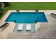 Inviting, refreshing pool with tan tile and lounge chairs at 696 Regatta Way, Bradenton, FL 34208