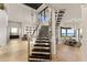 Modern staircase with glass railings and high ceilings at 696 Regatta Way, Bradenton, FL 34208