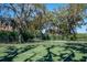 Well-maintained tennis court nestled amongst lush trees at 696 Regatta Way, Bradenton, FL 34208