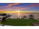 Breathtaking sunset view over calm water; boats on lifts at 696 Regatta Way, Bradenton, FL 34208