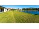 Large backyard with pond view and grassy area at 7228 Great Egret Blvd, Sarasota, FL 34241