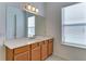 Well-lit bathroom with a large vanity mirror and wood cabinets at 7228 Great Egret Blvd, Sarasota, FL 34241