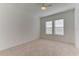 Bright bedroom with carpet flooring and two large windows at 7228 Great Egret Blvd, Sarasota, FL 34241