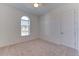 Bright bedroom featuring an arched window and neutral color scheme at 7228 Great Egret Blvd, Sarasota, FL 34241