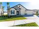 Tan house with a two-car garage and stone accents at 7228 Great Egret Blvd, Sarasota, FL 34241