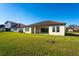Back exterior of house showcasing lawn and patio at 7228 Great Egret Blvd, Sarasota, FL 34241