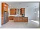 Open kitchen with island, stainless steel appliances, and wood cabinets at 7228 Great Egret Blvd, Sarasota, FL 34241