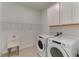 Laundry room with Whirlpool washer and dryer, and utility sink at 7228 Great Egret Blvd, Sarasota, FL 34241