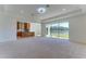 Bright living area with view of the lake from sliding doors at 7228 Great Egret Blvd, Sarasota, FL 34241