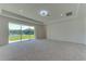 Bright main bedroom with large sliding glass doors leading to a beautiful lake view at 7228 Great Egret Blvd, Sarasota, FL 34241