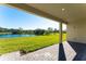 Covered patio overlooking a serene lake view, perfect for outdoor relaxation at 7228 Great Egret Blvd, Sarasota, FL 34241