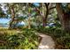 White gravel pathway winds through lush landscaping toward waterfront at 7505 4Th W Ave # 7505, Bradenton, FL 34209
