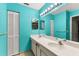 Bathroom with double vanity, light teal walls, and shower at 7505 4Th W Ave # 7505, Bradenton, FL 34209