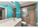 Bathroom with single vanity, shower, and teal walls at 7505 4Th W Ave # 7505, Bradenton, FL 34209