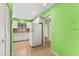 Bright kitchen with white cabinets, appliances, and green walls at 7505 4Th W Ave # 7505, Bradenton, FL 34209