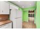 Kitchen area with white appliances and green walls at 7505 4Th W Ave # 7505, Bradenton, FL 34209
