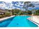 Community pool with lounge chairs and umbrellas at 7505 4Th W Ave # 7505, Bradenton, FL 34209