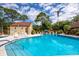 Community pool with lounge chairs and umbrellas at 7505 4Th W Ave # 7505, Bradenton, FL 34209