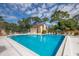 Community pool with lounge chairs and umbrellas at 7505 4Th W Ave # 7505, Bradenton, FL 34209