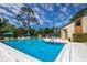Community pool with lounge chairs and umbrellas at 7505 4Th W Ave # 7505, Bradenton, FL 34209