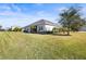 Spacious backyard with grassy lawn and home view at 7521 Ridgelake Cir, Bradenton, FL 34203