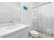 Clean bathroom with white vanity, shower/tub combo, and geometric shower curtain at 7521 Ridgelake Cir, Bradenton, FL 34203