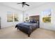 Primary bedroom with a ceiling fan and large windows at 7521 Ridgelake Cir, Bradenton, FL 34203