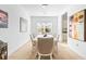Dining area with a large window, neutral walls and modern chandelier at 7521 Ridgelake Cir, Bradenton, FL 34203