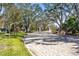 Community entrance with paved road and lush landscaping at 7521 Ridgelake Cir, Bradenton, FL 34203