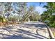 Community entrance with paved road and lush landscaping at 7521 Ridgelake Cir, Bradenton, FL 34203
