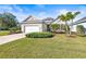 House exterior featuring a two-car garage and lush landscaping at 7521 Ridgelake Cir, Bradenton, FL 34203
