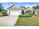 Single-story home with white garage door and landscaped lawn at 7521 Ridgelake Cir, Bradenton, FL 34203