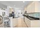 Modern kitchen with light-colored cabinets and granite countertops at 7521 Ridgelake Cir, Bradenton, FL 34203